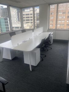 Professional office relocations Sydney team moving office desks